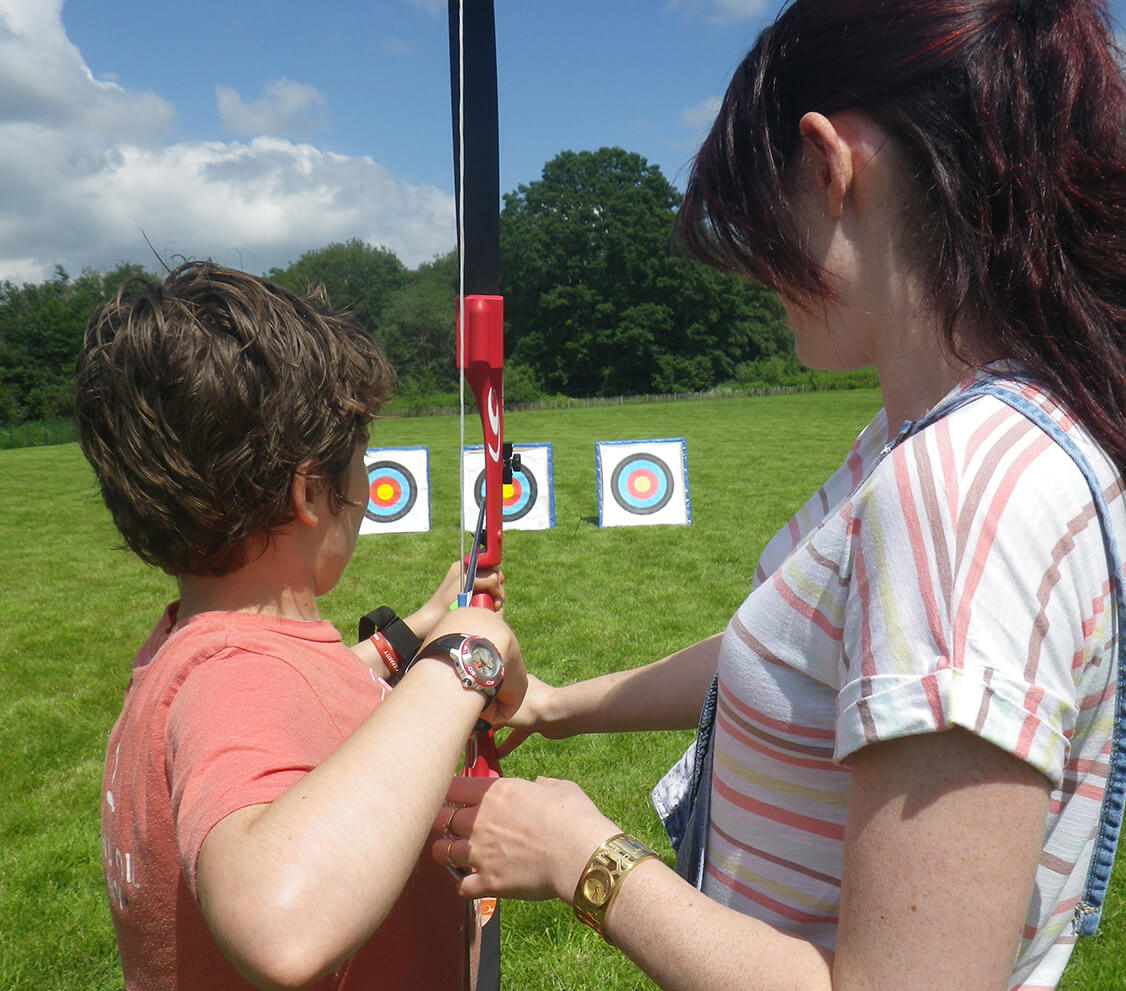 A child taking part in an outdoor Forest Pulse activity with an adult